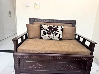 Solid wood 2-seater sofa with cushions. Hand made,customized from carpenter6 months back.barely used