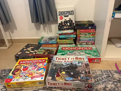 Books and bored games for sale (monopoly, rummy) (harry potter, tom gates and the sidemen book.