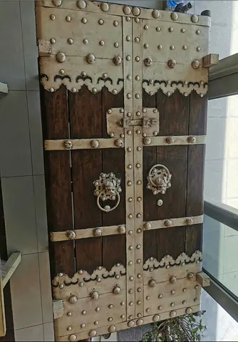 Antique-style Solid Wood Table with Metal Studs and Knockers, with free matching bench on cream.