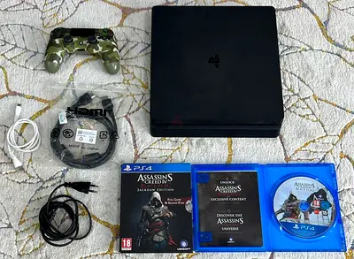 PlayStation 4 Slim 500gb with DualShock controller, cables and Assassins Creed games