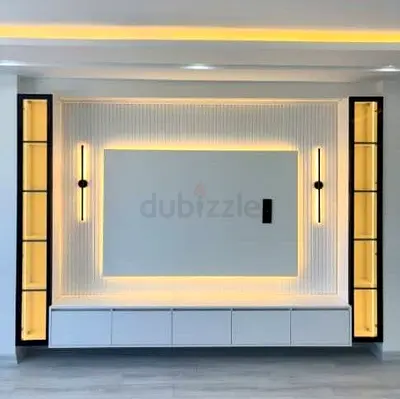 Modern built-in entertainment wall unit with LED lighting and display niches