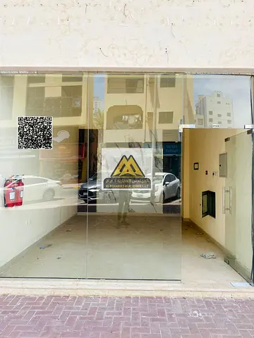 Shop for rent in Al Nakheel 1, second row from Ajman Corniche, prime and lively location with continuous activity, AED 33,000 per year, 4 installments