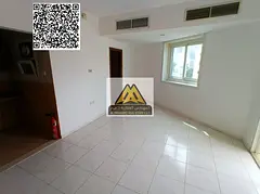 A studio for annual rent in Al Rashidiya 3 – Ajman, featuring a balcony, built-in wardrobes, a sep