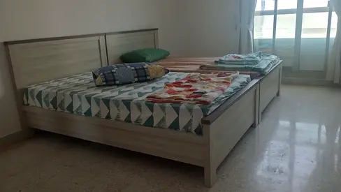 Pair of single beds with mattresses and headboards - light wood finish