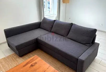 Dark grey L-shaped fabric sofa — comfortable 3-seater with chaise