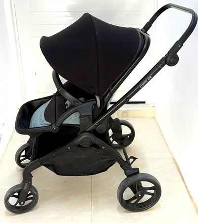 Used black baby stroller/pram - sturdy 4-wheel design