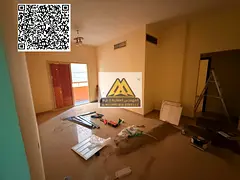 A 2-bedroom apartment with a living room for annual rent in Al Nuaimiya 2 – Ajman, featuring centr