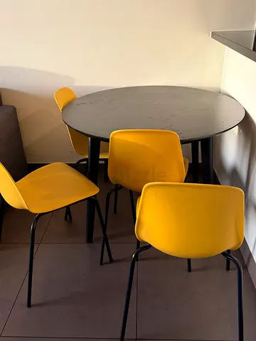 Round dining table with 4 yellow chairs - modern set