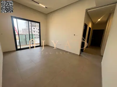 2BR apartment with hall in Al Alia, Ajman. Free month, 2 master bedrooms, built-in wardrobes, central AC, balcony, easy payments, high-end finish.
