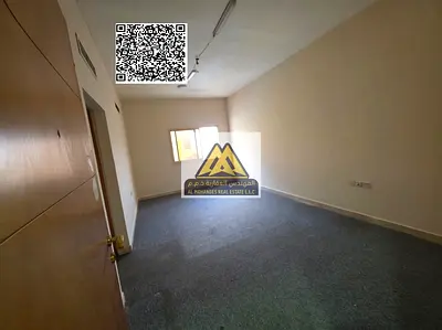 A spacious 1-bedroom apartment with a living room for annual rent in Al Nuaimiya – Ajman, located directly on Kuwait Street, close to all services, of