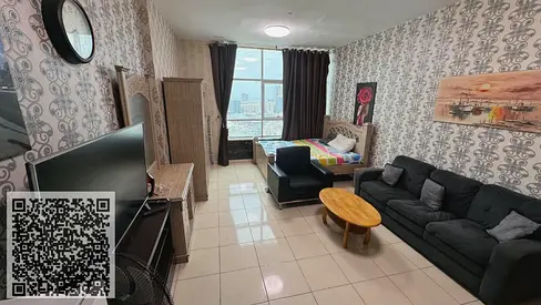 Studio apartment for sale in Orient Towers, Ajman, with parking and an open view of the creek.