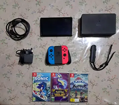 Nintendo Switch OLED with dock, Joy‑Con, charger,HDMI, grips and 3 games (Sonic,Pokémon)