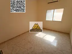 A spacious studio for annual rent in Al Rawda 3 – Ajman, featuring a separate kitchen and split AC