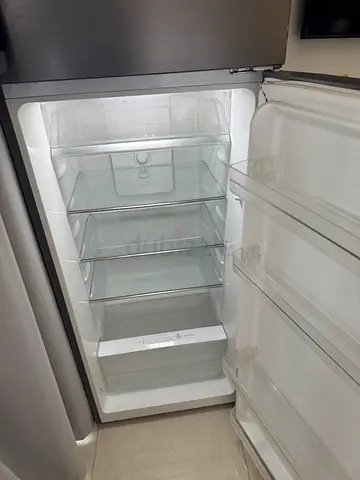 Empty single-door refrigerator with clear glass shelves - good condition