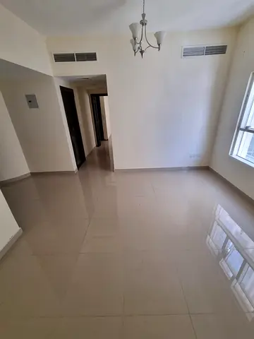 Apartment for rent in Sharjah Abu Shagara one bedroom and hall spacious two bathrooms central AC built in wardrobe prime location near services yearly