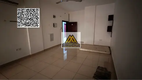 Studio apartment for rent in Al Rawda 2, Ajman, with a large area and a semi-separate kitchen, inside a clean building designated for families, in a v