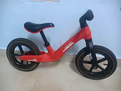 Red balance/runner bike for toddlers — lightweight, good condition