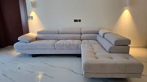 Light grey L-shaped fabric sectional sofa with adjustable headrests
