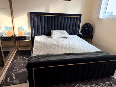Queen size black velvet bed with padded headboard and footboard