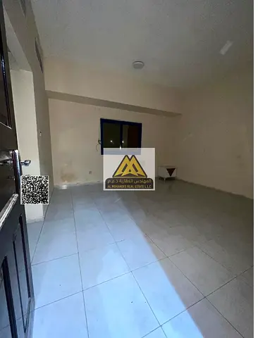 Ground-floor one-bedroom apartment with a living room in Al Nuaimiya 2, Ajman. Large space, prime and lively location, AED 26,000 per year in 4 paymen