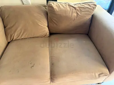 Used 2-seater beige fabric sofa - good structure, some stains