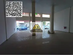 A commercial shop for annual rent in Al Mowaihat 2 – Ajman, featuring a large space and a prime lo