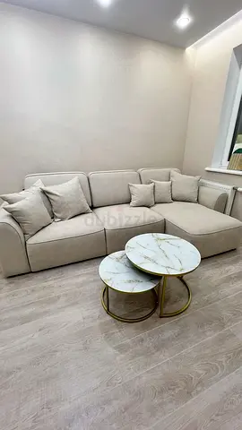 Light beige L-shaped fabric sofa with cushions