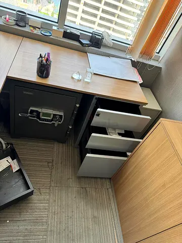 Modern wooden L-shaped executive office desk with file cabinet