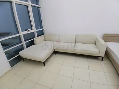 Light beige L-shaped fabric sofa with chaise - good condition