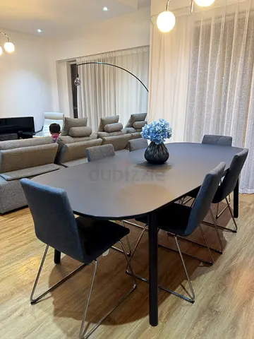Modern black dining table with 6 grey chairs - good condition