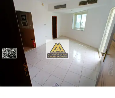 Studio in Al Rashidiya 3 with balcony, built-in wardrobes, separate kitchen, central AC. 18,000 yearly, 4 payments, maintenance by owner, prime locati