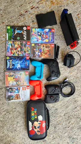 Nintendo Switch OLED bundle with 2 Pro controllers, Joy-Con grips, case and 7 games, 128 GB card