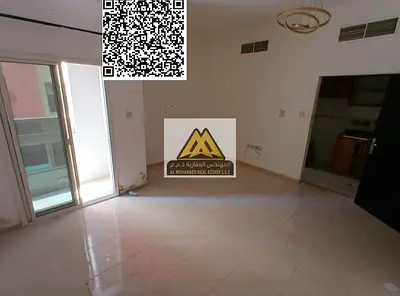 A studio for annual rent in Al Nuaimiya 2 – Ajman on King Faisal Street, featuring a separate kitchen, a nice balcony, central air conditioning, and f