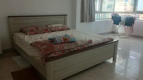 Light wood double bed frame with mattress included.