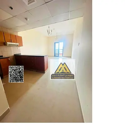 For annual rent: studio in Al Nuaimiya 1 (Al Nuaimiya Tower C), large space, balcony, private parking, good finishing, near Al Hikma School, 24,000 AE