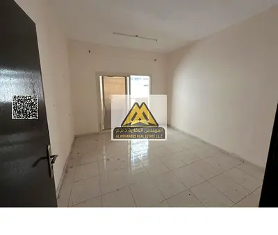 One-bedroom apartment with living room in Al Nuaimiya 1, Ajman, large space, balcony, prime location near Al Hikma School and Emirates Markets, on a m