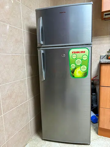 Silver double-door refrigerator with top freezer - good working condition