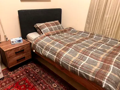 Single wooden bed with upholstered headboard and mattress — good condition