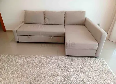 Light grey L-shaped sofa with storage and pull-out bed (right chaise)