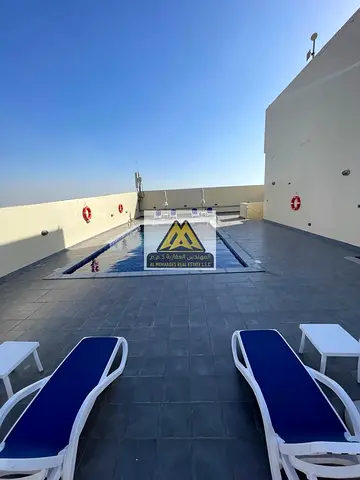 Emirates City, Ajman, located in a luxury residential tower featuring a high floor and open views of Ajman and Sharjah, ideal for family living in a m