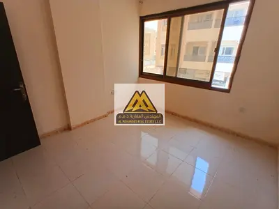 One-bedroom apartment with hall in Al Alia, Ajman, 2 bathrooms, suitable space. 27,000 yearly, 4 payments. Prime location, close to services, easy acc