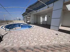 Full rooftop for yearly rent in Ajman Corniche, 10,000 sqft, suitable for any activity, includes swi