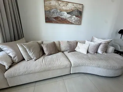 Light beige curved 3-seater sofa with chaise lounge. Clifton 3-Seater Fabric Right Corner Sofa