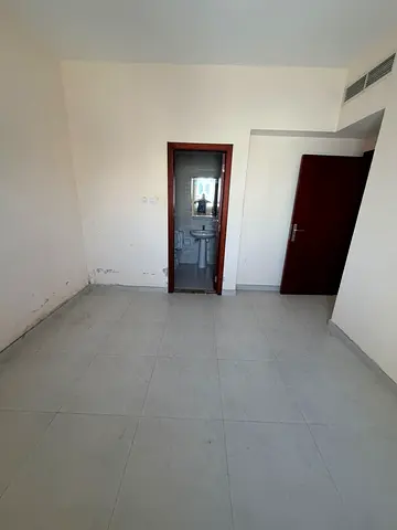 For annual rent in Al Taawun Sharjah 1BR hall on main road near Dubai bus master room 2 baths central AC 38000 AED 4 or 6 payments 2000 deposit