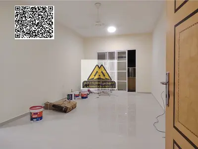 A 1-bedroom apartment with a living room for annual rent in Al Rawda 2 – Ajman, featuring a spacious layout and a balcony with an open view, located i
