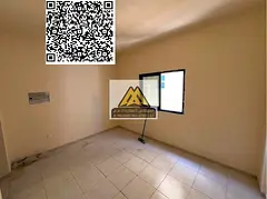 A spacious studio for annual rent in Al Nuaimiya 2 – Ajman, featuring a semi-separated kitchen and