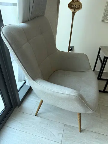 Light grey upholstered accent chair with wooden legs