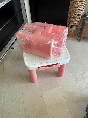Pink plastic children’s table and chairs
