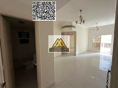 A 2-bedroom apartment with a living room for annual rent in Al Nuaimiya 1 – Ajman, featuring 2 bathrooms, a balcony, central AC, and a spacious layout
