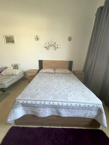 Queen size bed with two side tables